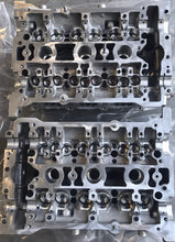 Load image into Gallery viewer, 2.8 cylinder heads rebuilt with upgraded exhaust valves/ guides with new cam chain tensioners assembled for 2.7 application